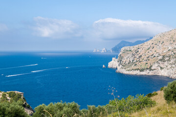 Capri faraglioni on the backgound of Amalfi coast, Southern Italy