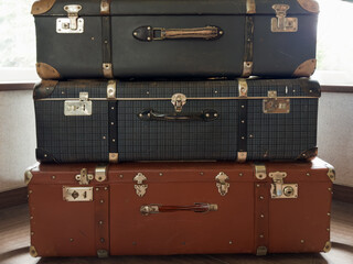 Stacked old big shabby hardshell suitcases made with leatherette