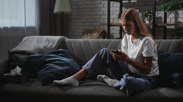 Woman Sitting Alone on Sofa in Contemplative Mood