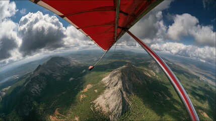 Wide Angle Action Shot of Hang Glider Flying Over Mountain Landscape