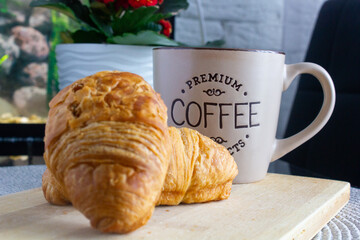 cup of coffee and croissant on the table, morning, breakfast, snack, breakfast in the kitchen,