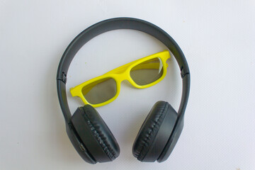 black headphones and yellow glasses, headphones listen to music, glasses, 3D glasses for cinema,...