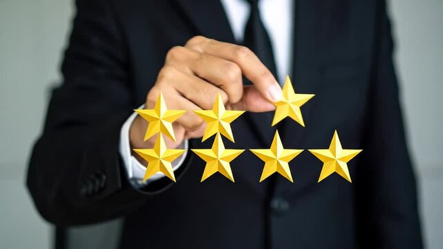 A person in a suit holding up gold stars