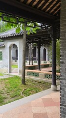 A quiet walkway winds through archways and shadows, where time rests among carved walls and tiled...