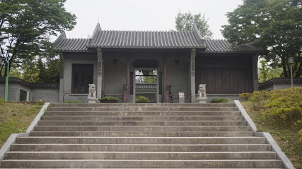 A quiet path leads up the stairs to a timeless stone gate, evoking reverence, tradition, and peaceful symmetry.