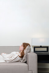 Woman relaxing on the sofa listening to the music