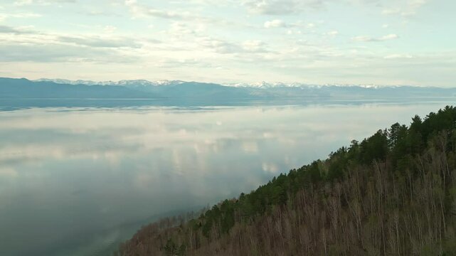 Spring landscape of Lake Baikal with a view of clear water and high rocky hills