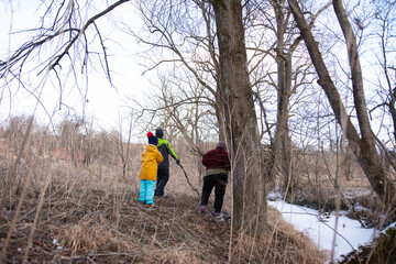 Embarking on an adventure with friends as we explore the tranquil beauty of winter nature beside a frozen creek on a crisp, chilly afternoon