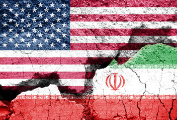 US american and Iran flags on cracked ground background. Crisis and war between Washington and...
