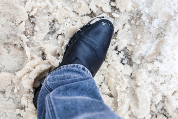 Winter Footwear in Slushy Mud and Melting Snow: A Close-Up of Resilient Style and Seasonal Challenges.
