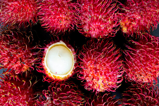 rambutan, sweet red rambutan fruit isolated on black background