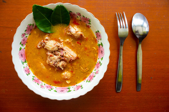 chicken curry or kari ayam served on bowl, isolated on white background
