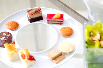 Assorted delicious desserts and cakes exquisitely arranged on table, close-up, festive celebration, buffet