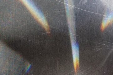 scratched vintage glass texture with iridescent rainbow light refraction, abstract grunge overlay...