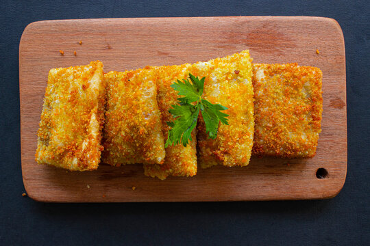 Fried Risoles or Risol Mayo are Indonesian snacks. Like Coxinha de Galinha. served with chili sauce, celery on wood board