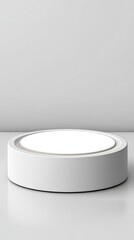 Minimalist white round platform on plain light gray background for product display