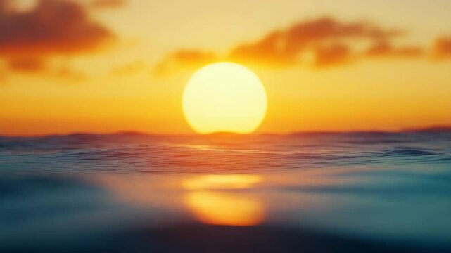 Sunset ocean horizon with warm glowing sun and soft clouds creating peaceful and calming atmosphere over gentle water waves and soft waves warm orange sky nature sea water wave sky clouds sun horizon