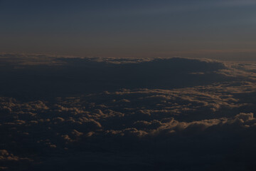 A calming aerial view of clouds at twilight with a gradient sky fading into darkness.