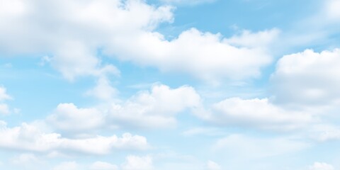 Obraz premium Bright blue sky with fluffy white clouds and sunny weather over a scenic landscape