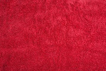 Fototapeta premium Close-up of a red terrycloth towel, showcasing its soft, plush texture and vibrant color