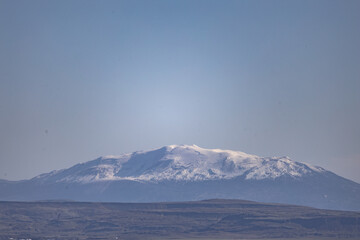 Stunning view of a snow-covered mountain under a clear blue sky, capturing natural serenity.