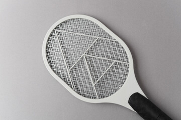 Electric mosquito swatter on gray background
