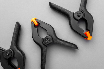 Closeup of black plastic clamps with orange tips