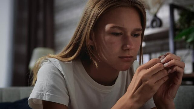 Contemplative Young Woman Sitting in Home Interior