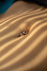 close-up view of navel piercing