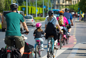 Naklejka premium People on bikes riding in designated bicycle traffic lane