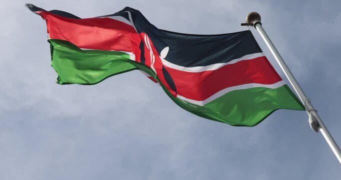Video of the Kenyan Flag in 4K format. The flag of Kenya, waving against the background of the blue sky, is the national symbol of Kenya. Independence Day. The flag is in close-up. Great for news.