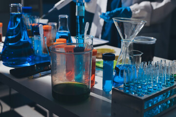 Scientist pipetting medical samples into microplate in laboratory