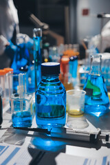 Scientist pipetting medical samples into microplate in laboratory