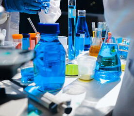 Scientist pipetting medical samples into microplate in laboratory