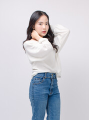 Half body portrait happy smile young asian beautiful woman curly hair wearing long sleeve shirt, blue jeans outfit, casual standing pose on white background joy positivity fashion lifestyle concept.