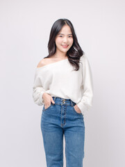Half body portrait happy smile young asian beautiful woman curly hair wearing long sleeve shirt, blue jeans outfit, casual standing pose on white background joy positivity fashion lifestyle concept.