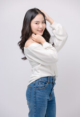 Half body portrait happy smile young asian beautiful woman curly hair wearing long sleeve shirt, blue jeans outfit, casual standing pose on white background joy positivity fashion lifestyle concept.