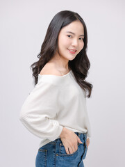 Half body portrait happy smile young asian beautiful woman curly hair wearing long sleeve shirt, blue jeans outfit, casual standing pose on white background joy positivity fashion lifestyle concept.