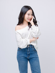 Half body portrait happy smile young asian beautiful woman curly hair wearing long sleeve shirt, blue jeans outfit, casual standing pose on white background joy positivity fashion lifestyle concept.