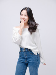 Half body portrait happy smile young asian beautiful woman curly hair wearing long sleeve shirt, blue jeans outfit, casual standing pose on white background joy positivity fashion lifestyle concept.