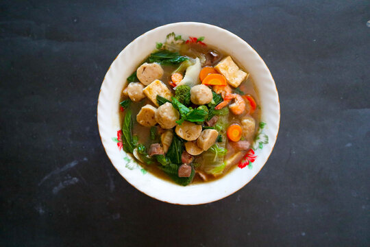 "sapo tofu or sapo tahu food from china (Chinese food) made from tofu, vegetables, shrimp, mushrooms, and meatball. sapo tofu served on bowl"