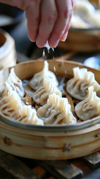 A steaming basket of Mongolian buuz, savory steamed dumplings filled with meat, traditionally enjoyed during Tsagaan Sar.
