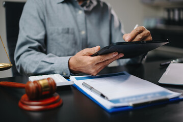 Senior legal advisor using tablet to review digital contract in office. Concept of law, legal tech,...