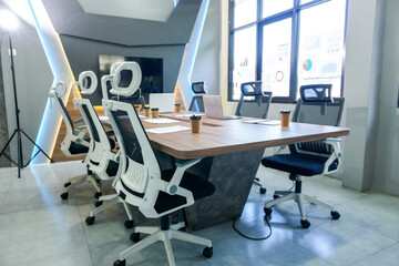 A Meeting Room Features Large Wooden Conference Table Surrounded by Ergonomic Office Chairs