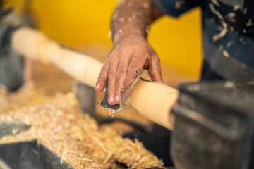 Carpenter working on wood to sanding.