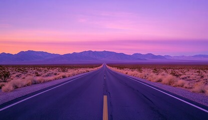 Fototapeta premium Empty road stretching into a vibrant, purple-pink sunrise over a desert landscape