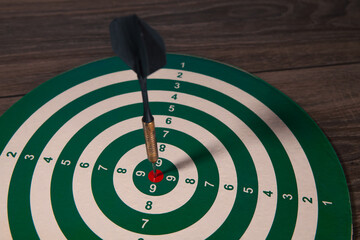 dart arrow in the center of dartboard