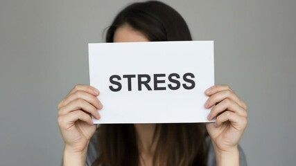 Woman Holding Sign with Stress Word in Front of Face Showing Anxiety and Overwhelm