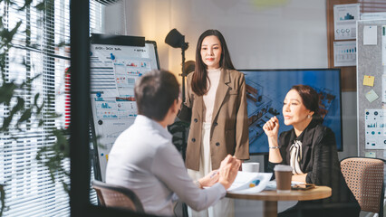 Business culture asian team working together meeting positive emotion at modern office