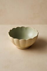 A beautifully crafted ceramic bowl with a unique scalloped design and a serene color palette. Its elegant form and textured surface give a visual treat